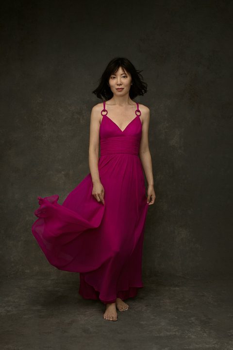 Studio portrait of pianist Zi Liang in pink flowy dress