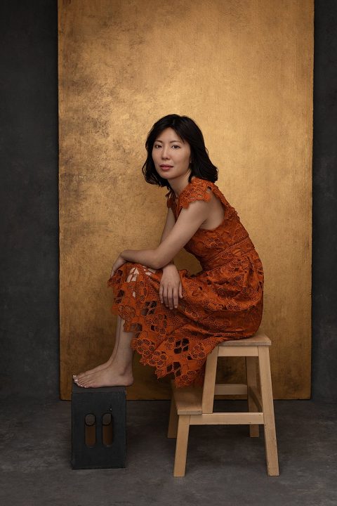 Portrait of Zi, seated, wearing a lace dress with gold background