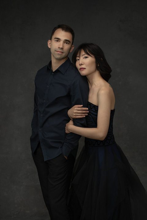 Portrait of piano duo Adam Mayon and wife Zi Liang, wearing dark colors