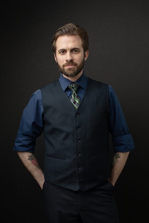 Men's portrait - black background - vest, tie, tattoos