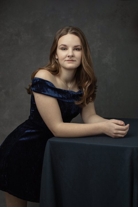Senior photo of Laurel wearing a blue velvet dress
