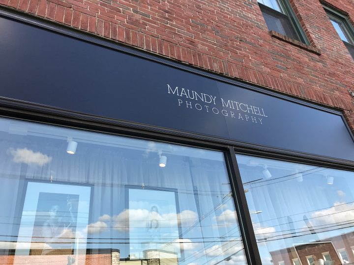 The main sign for Maundy Mitchell Photography at 62 Main Street, Plymouth, NH