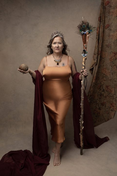 Portrait of a woman wearing gold, holding a scepter and a stone