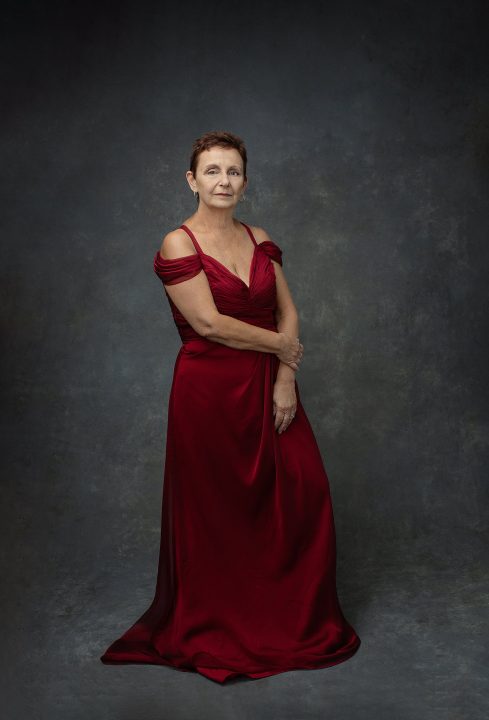 Portrait of a woman wearing a long red silk gown
