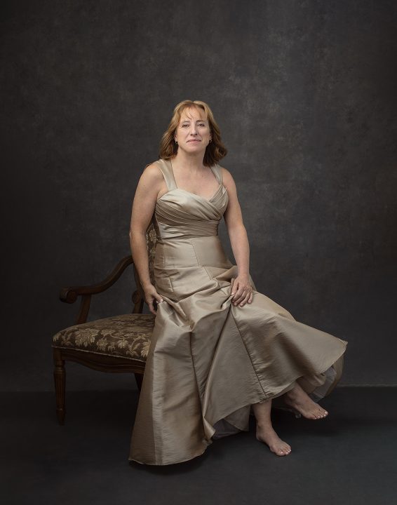 A portrait by Maundy Mitchell of a client over 50 wearing a beige taffeta gown