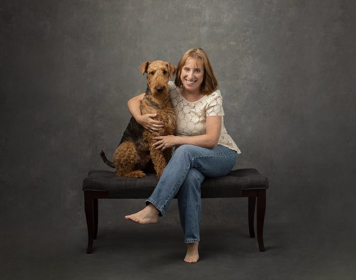 Portrait of a woman with her Airedale Terrier