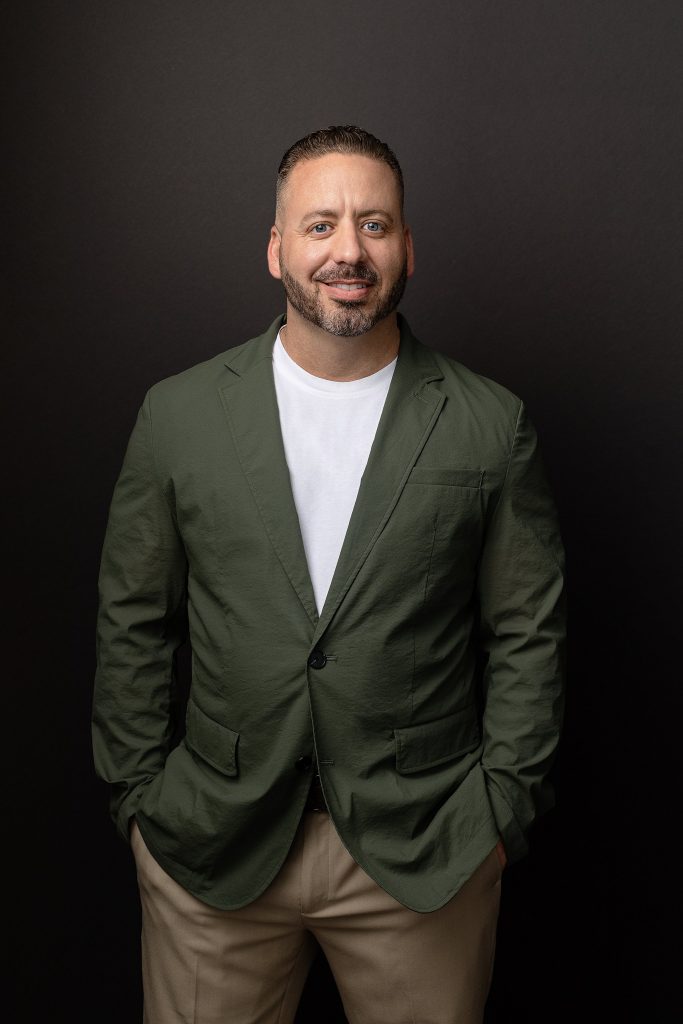 A business casual portrait with a black background for a Realtor