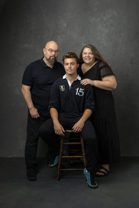 A family portrait with high school senior boy