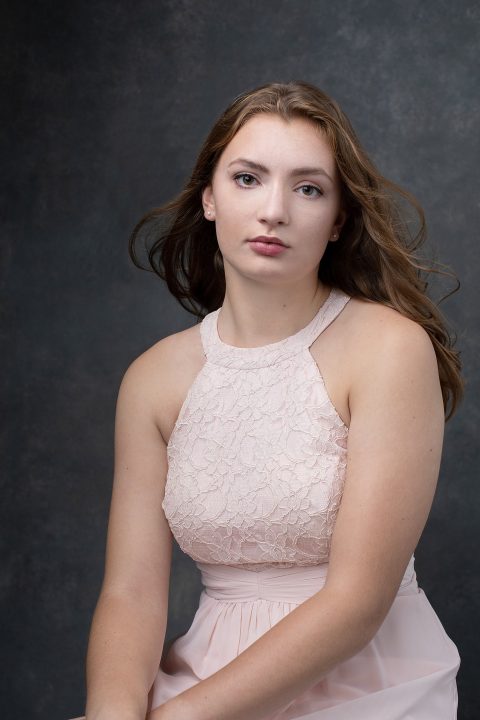 Senior photo of Lindsay wearing a pink dress