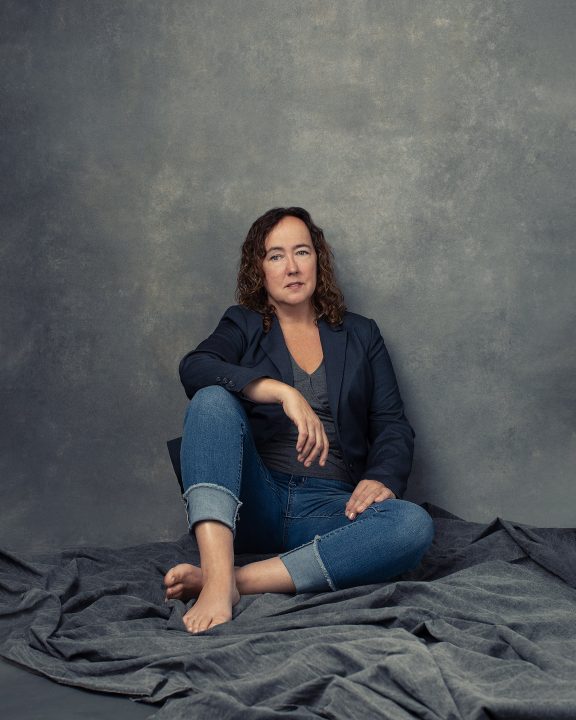 Portrait of singer-songwriter Audrey Drake, seated on floor