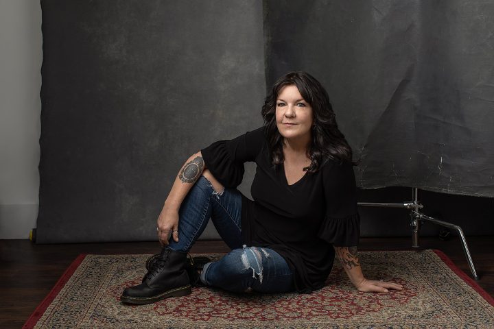 A "dirty frame" portrait of Kree, sitting on a vintage rug