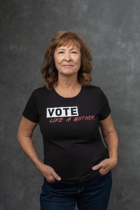 Karen, in a portrait for the Over 50 Revolution campaign, wearing a VOTE t-shirt