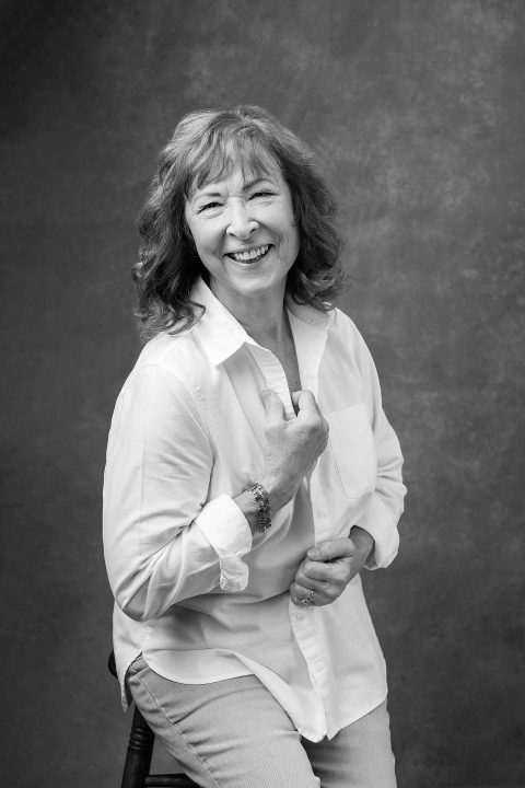 Black and white portrait of Karen, laughing