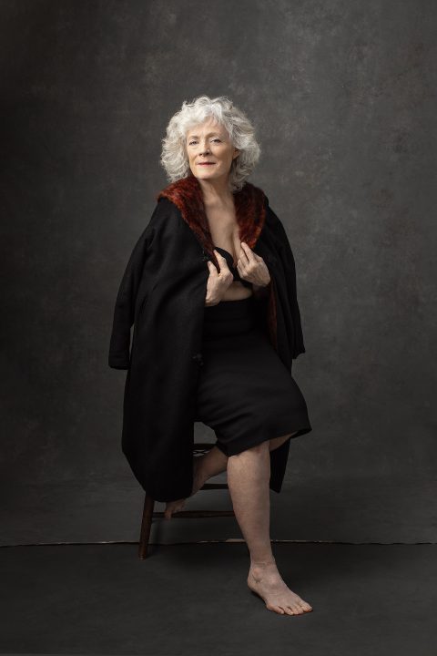 Portrait of a woman with white hair and draped in a coat - part of Maundy Mitchell's "Unforgettable: the Over 50 Revolution" campaign 2022