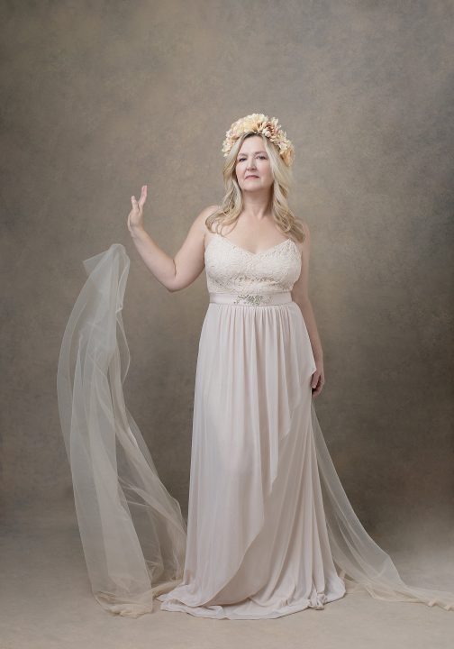 Portrait of MaryEllen wearing flowers and neutral tones during her Over 50 Revolution photo session