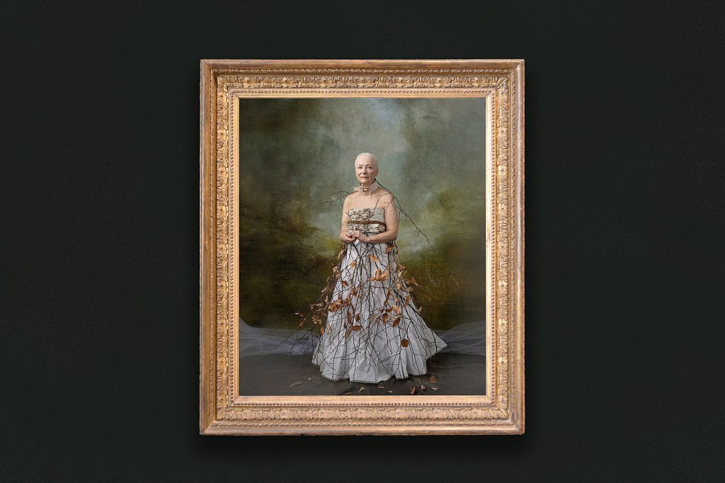 A gold framed portrait on a dark wall