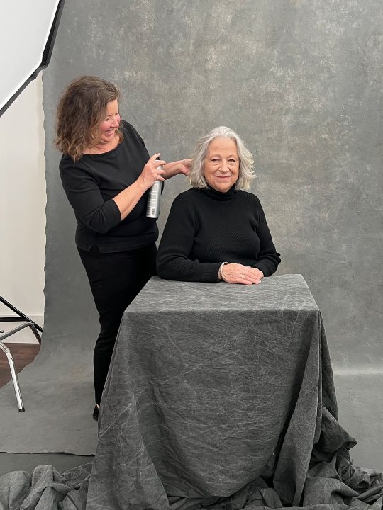 Behind the scenes at Maundy Mitchell Photography - Liz with hair and makeup stylist during her Over 50 Revolution photo session