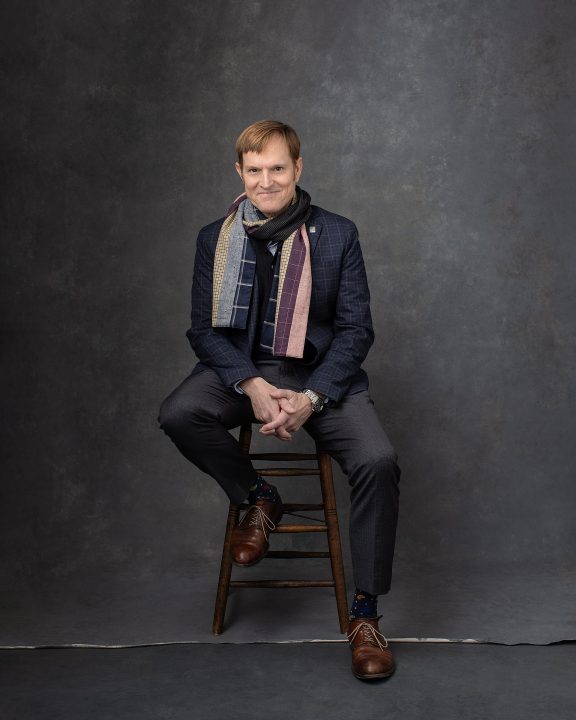 Casual studio portrait of PSU Provost Nate Bowditch wearing a scarf