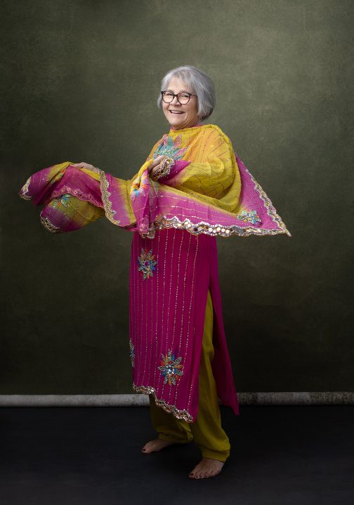 Portrait from Extraordinary: the Over 50 Revolution - Rebecca laughing, wearing a colorful outfit from India