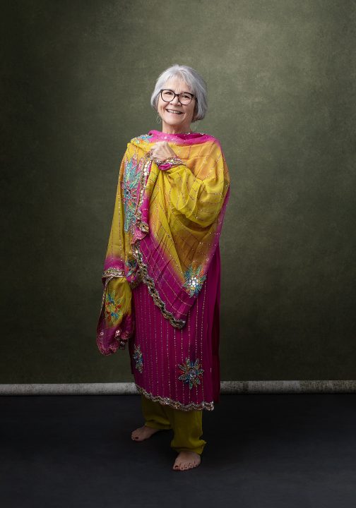 Portrait from Extraordinary: the Over 50 Revolution - Rebecca smiling, wearing a colorful outfit from India