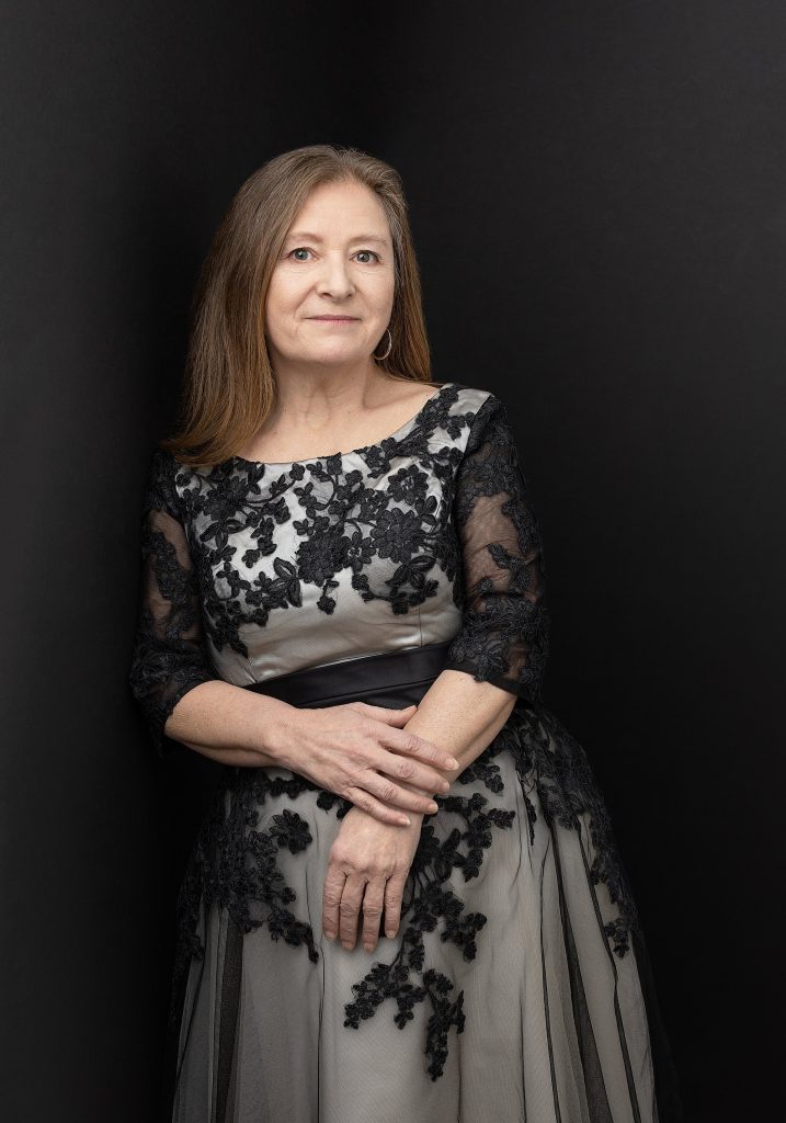 A portrait of Kathy wearing a 1950s lace dress as part of her portrait experience for Extraordinary: the Over 50 Revolution