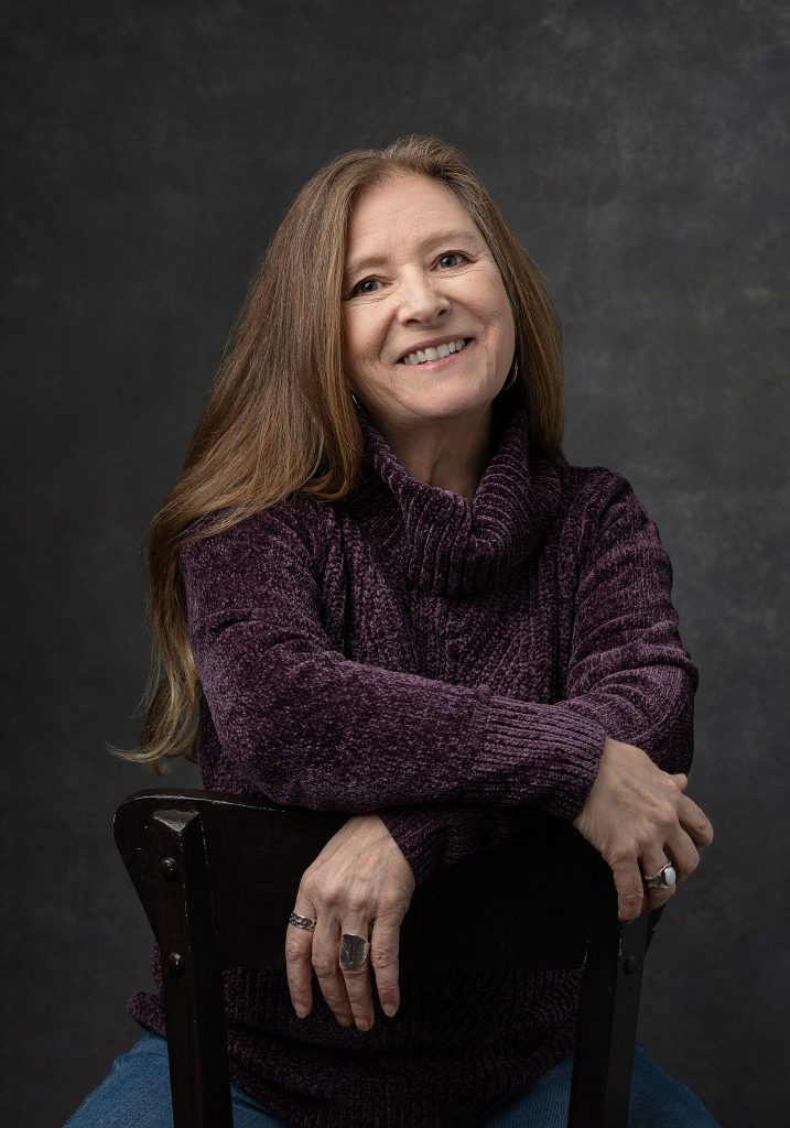 A casual photo of Kathy G. wearing a purple sweater - from Extraordinary - the Over 50 Revolution