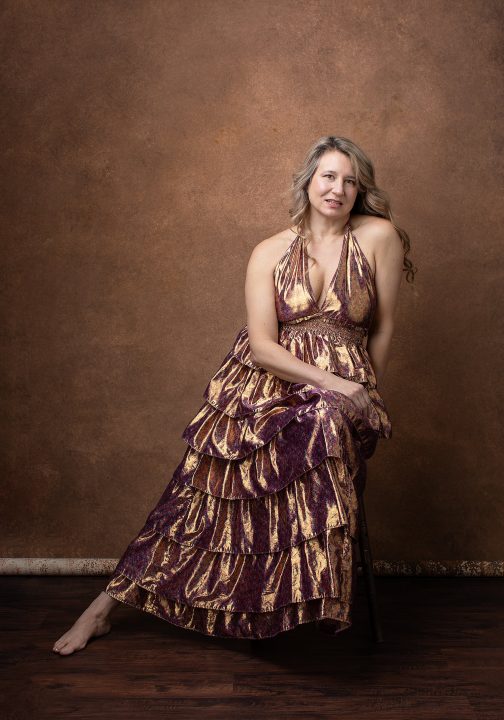Portrait of Amanda wearing a shiny copper dress for Extraordinary: the Over 50 Revolution