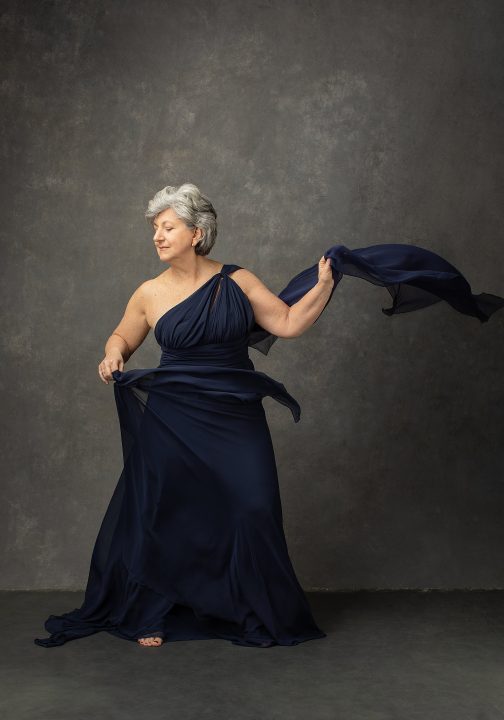 Portrait of Susan C. dancing in flowy blue gown