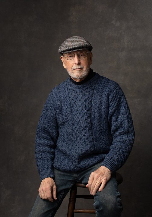 Portrait of a man wearing a cap and wool Irish sweater