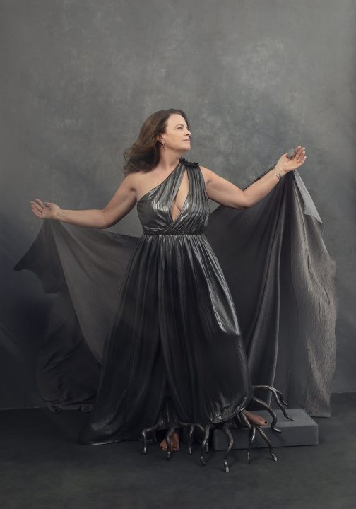 Portrait of Heidi wearing silver gown and metal "roots"