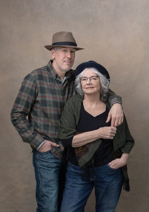 A portrait of an older couple wearing hats