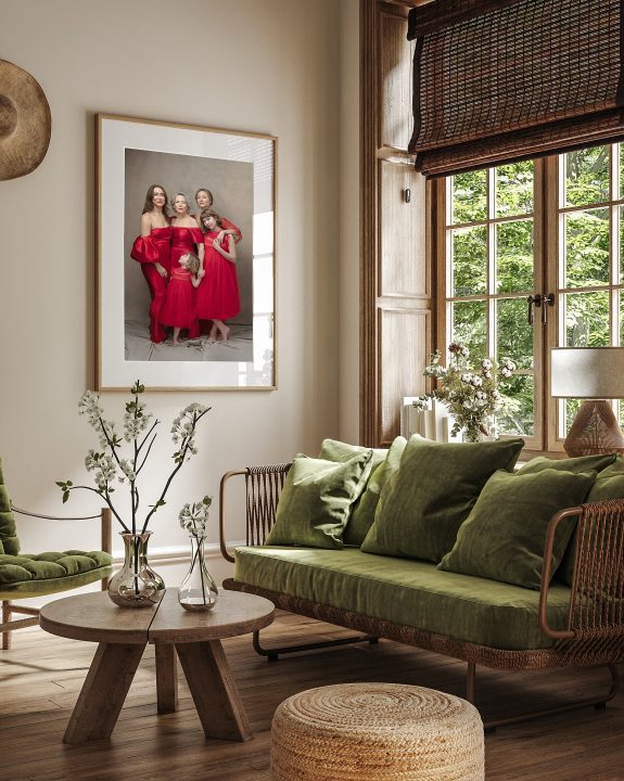 A photo of a living room with a large custom framed wall portrait of three generations