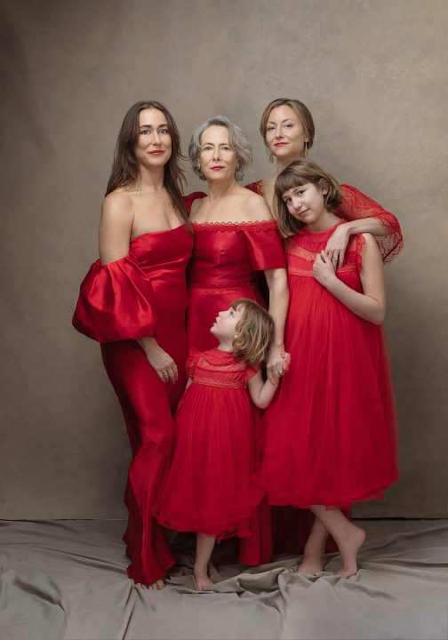 Three generation portrait in red dresses