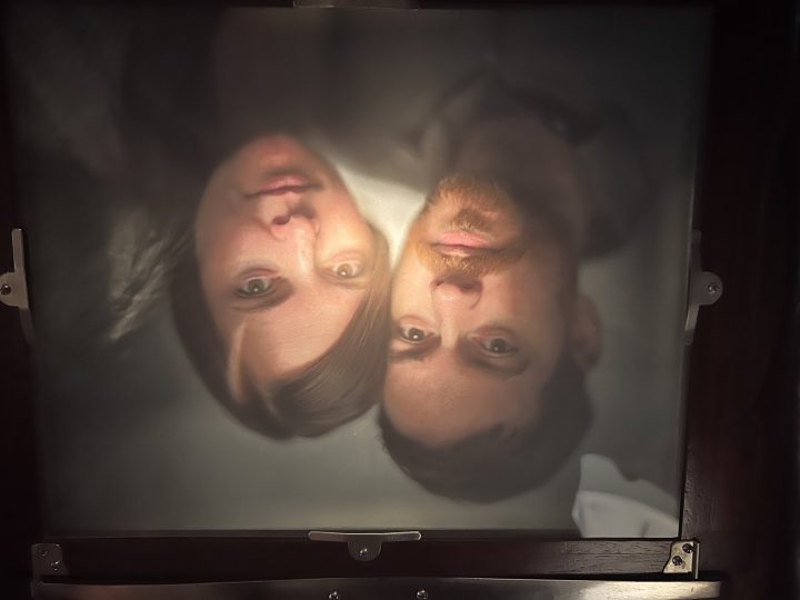 The upside-down view of Matt and Lauren through the antique camera