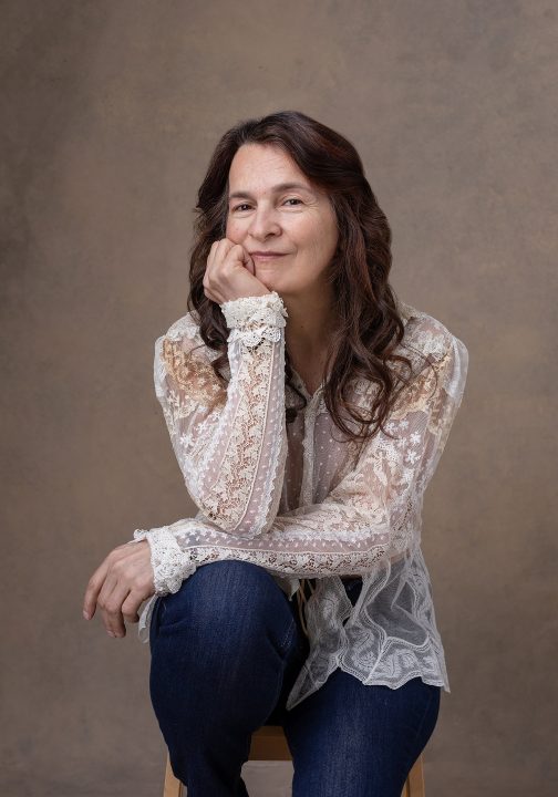Portrait of Deb wearing a lace top and jeans for the Over 50 Revolution portrait experience