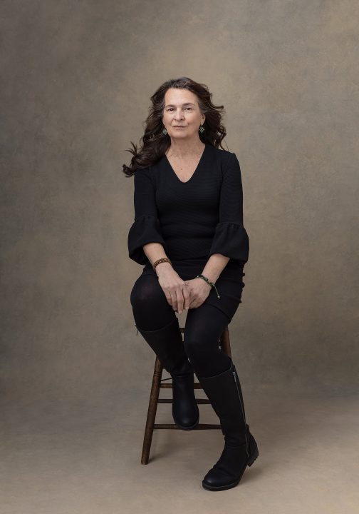 Portrait of Deb seated, wearing black for the Over 50 Revolution at Maundy Mitchell Photography