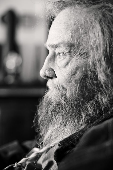 Black and white profile photograph of poet Donald Hall. ©Maundy Mitchell, all rights reserved