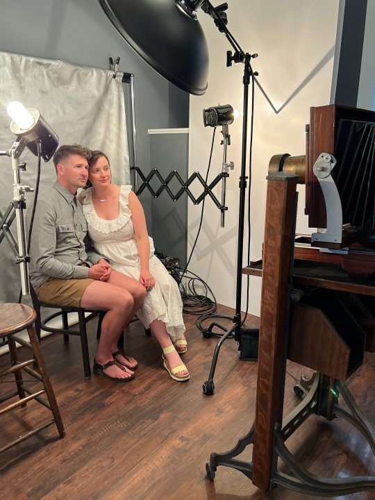 A couple posing for a tintype portrait