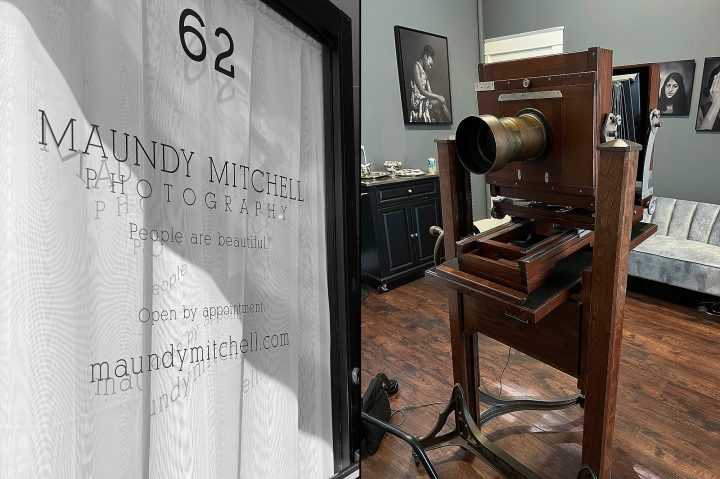 A photo of Maundy Mitchell's studio door and a photo of the antique Deardorff camera and Dallmeyer lens