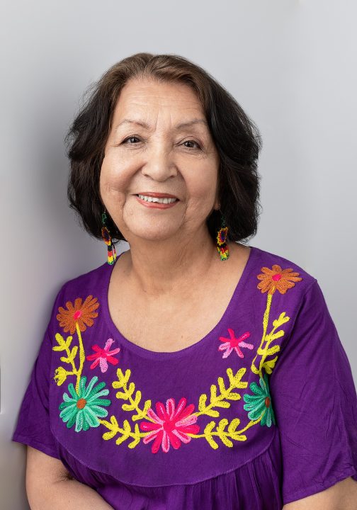 Maria, wearing a purple embroidered dress for her portrait session for Extraordinary: the Over 50 Revolution