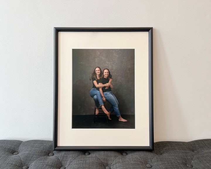 A custom framed wall portrait of sisters