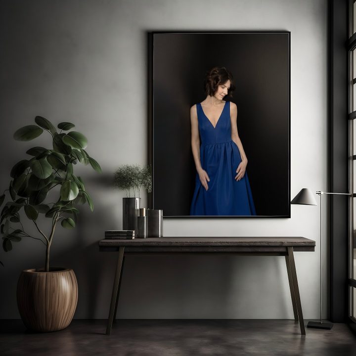A framed wall portrait of Karen wearing a blue gown