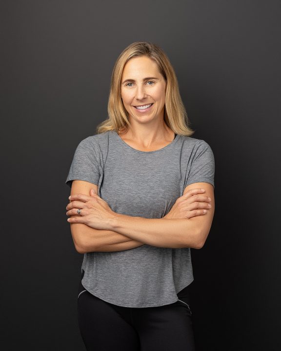 Casual business portrait with black background - Courtney van Etten, owner of Functional Fitness