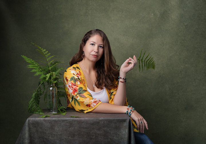 Portrait of Molly with green background and ferns