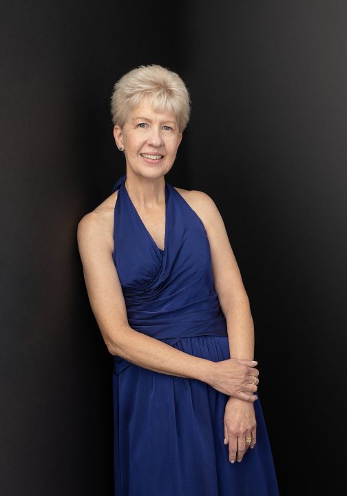 Portrait of Debbie wearing a blue halter dress for Extraordinary: the Over 50 Revolution
