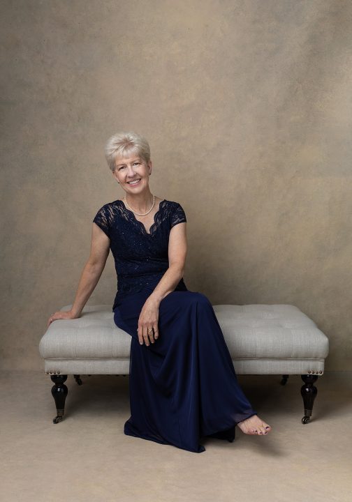 Debbie wearing a navy gown for Extraordinary-the Over 50 Revolution portrait session at Maundy Mitchell Photography in NH