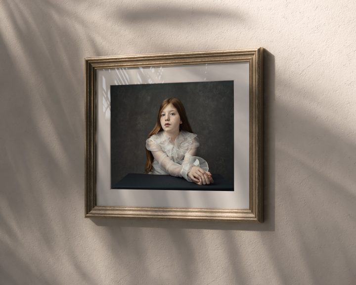 Custom framed wall art - a gold-framed portrait of Ellie, a tween, from her portrait experience at Maundy Mitchell Photography