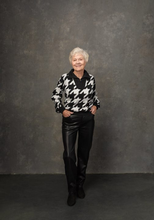 Portrait of Sharon wearing leather pants and a sweater for the Over 50 Revolution