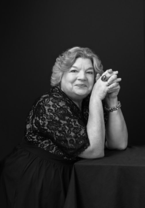 Black and white portrait of Maria wearing a lace dress for her Over 50 Revolution photo session