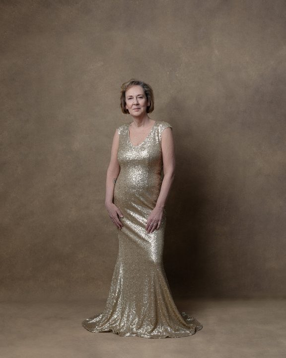 Terri wearing a gold gown during her session for The Over 50 Revolution